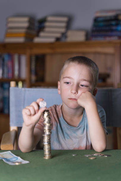 istock Young boy piling up his pocket money 1409461235