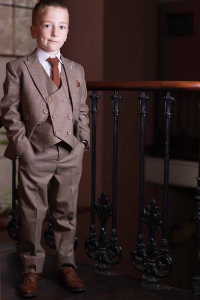 istock Well-dressed little boy on the staircase 1409461305