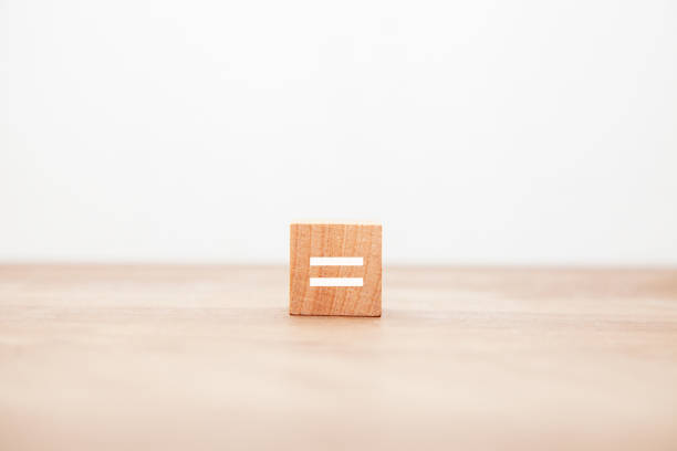 istock = Symbol. equal. equal. same. Written on a wooden block. Black letters 1409461529