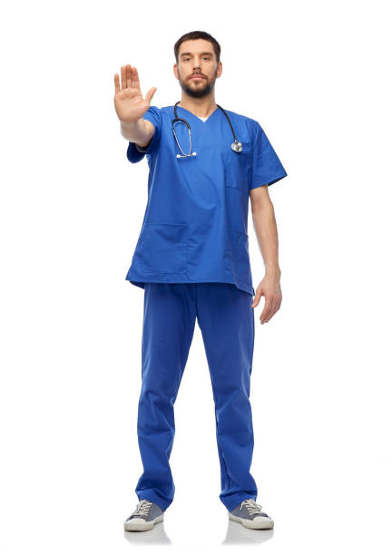 istock doctor or male nurse showing stop gesture 1409461774
