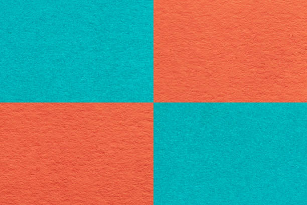 istock Texture of craft orange and turquoise paper background with cells pattern, macro. Structure of vintage cyan cardboard. 1409462549