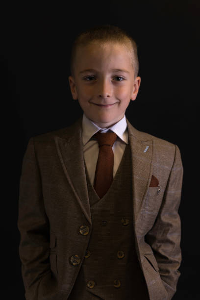 Small boy wearing a smart suit.