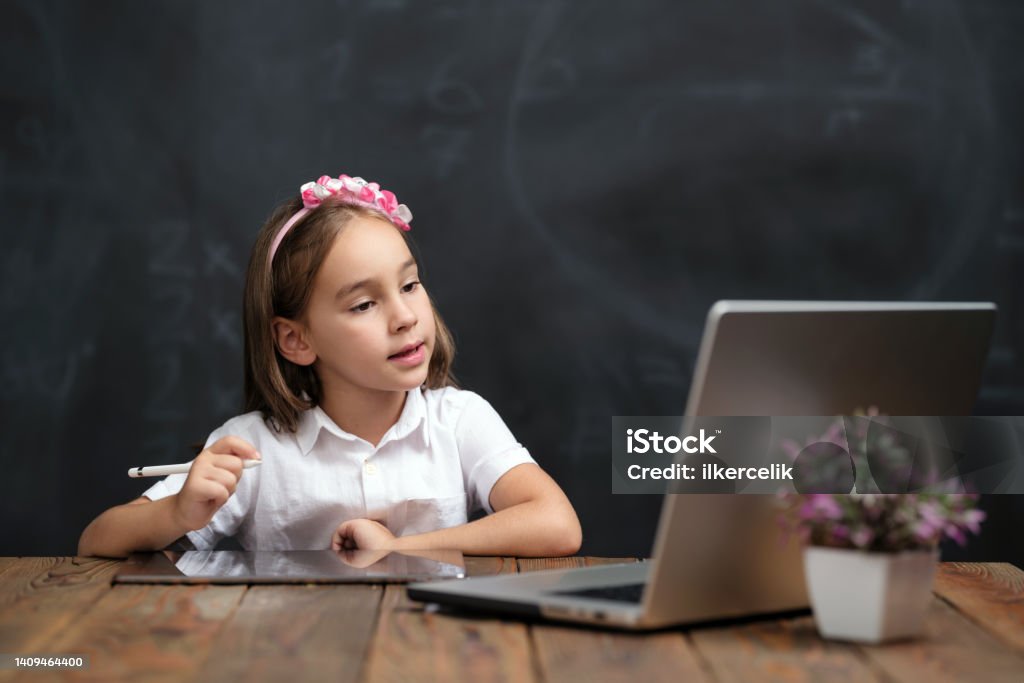 Back To School Concept, Happy Smiling Child Student Using Laptop Computer And Digital Tablet, Attending Remote Education Back to School Stock Photo