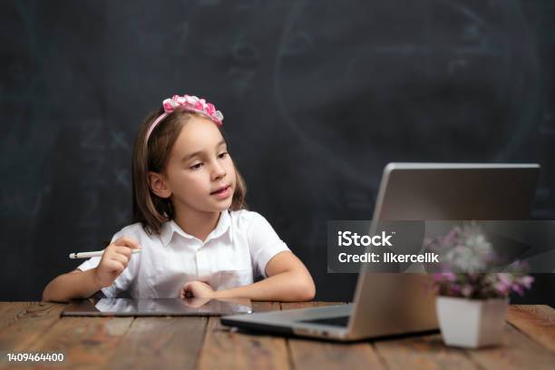 Back To School Concept Happy Smiling Child Student Using Laptop Computer And Digital Tablet Attending Remote Education Stock Photo - Download Image Now