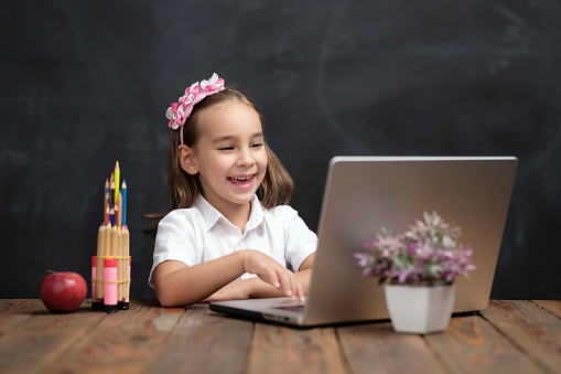 Back To School Concept, Happy Smiling Child Student Using Laptop Computer And Attending Remote Education