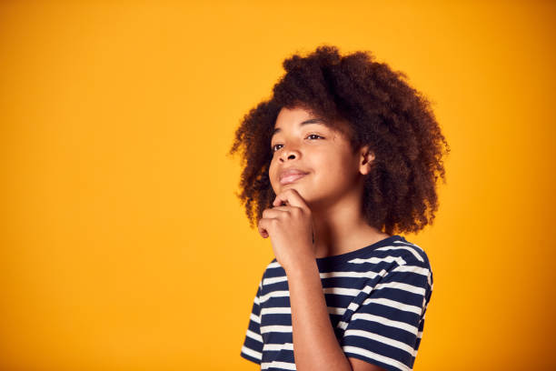 istock Studio Shot Of Boy With Puzzled Expression Thinking Against Yellow Background 1409464633