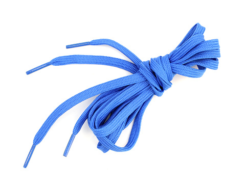 Blue shoelaces flat on a white background. Bundled sports laces. flat shoelaces tied up set is isolated on a white background. Top view.