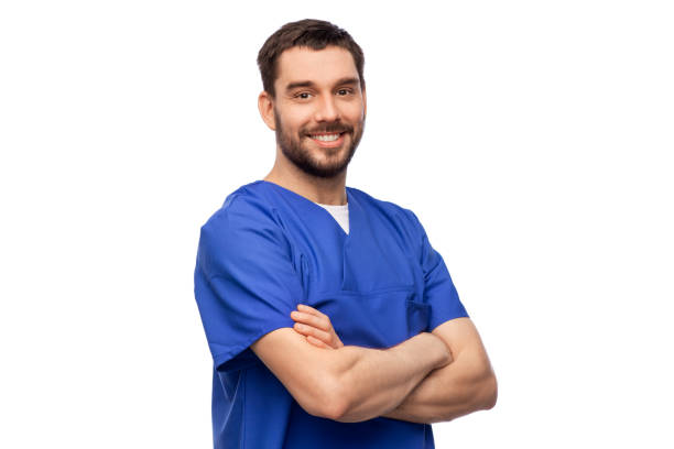 happy smiling doctor or male nurse in blue uniform - nurse doctor scrubs male imagens e fotografias de stock