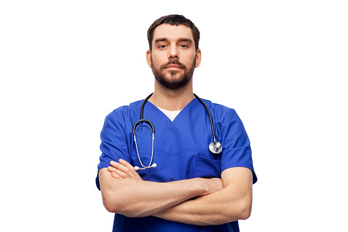 healthcare, profession and medicine concept - doctor or male nurse in blue uniform with stethoscope over white background