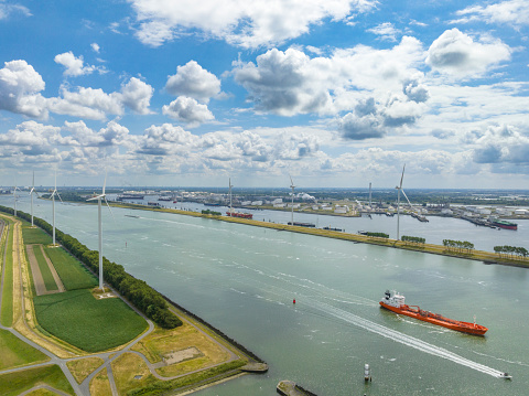 Nieuwe Waterweg canal in the port of Rotterdam with a Tanker ship for transporting chemical or oil products sailing on calm water seen from above.