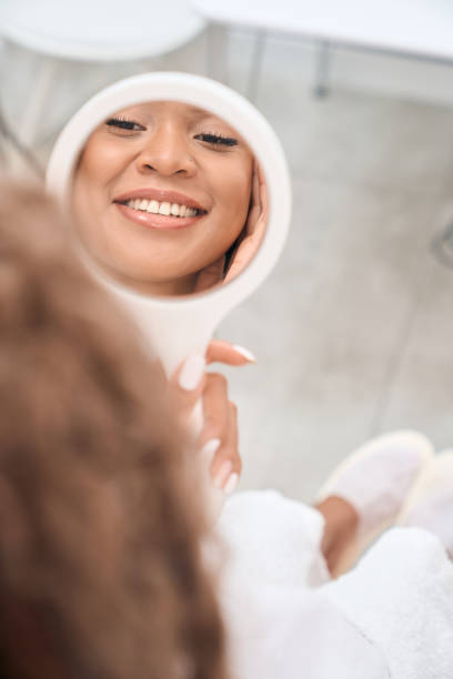 istock Woman admiring her reflection in the mirror 1409471098