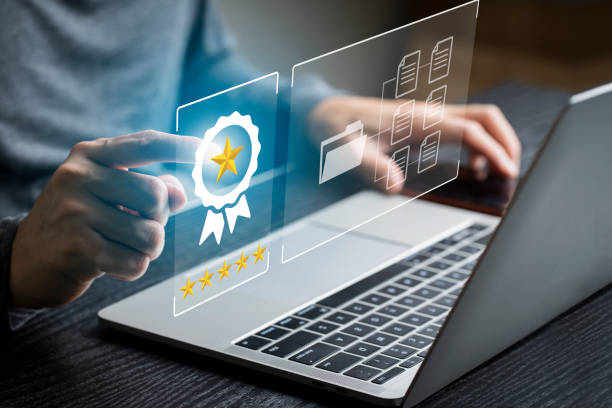 Businessman using computer laptop with popup rating icon for feedback review , Customer give rating to service experience on online application for giving best score stock photo
