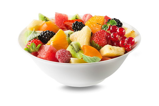 Fresh salad bowl with mixed fruits isolated on white background. Healthy food.