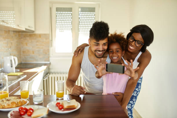 istock Cheerful family taking Selfie during breakfast 1409473734
