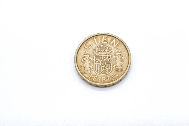 istock 100 pesetas old spanish coins on white background 1409473789