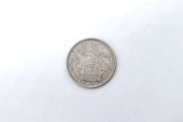istock 5 pesetas 1957 old spanish coins on white background 1409473796