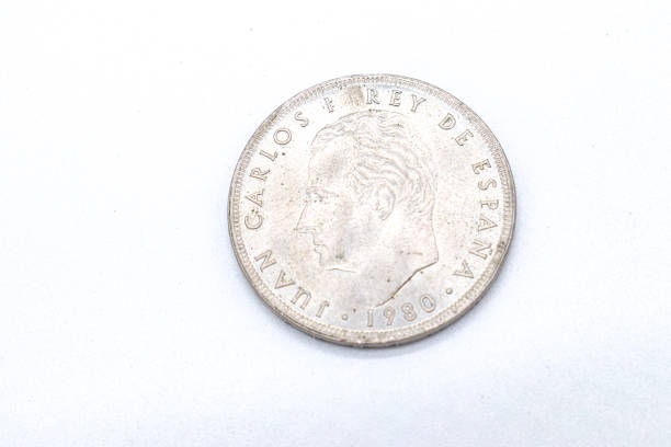 istock 100 pesetas old spanish coins on white background 1409473822