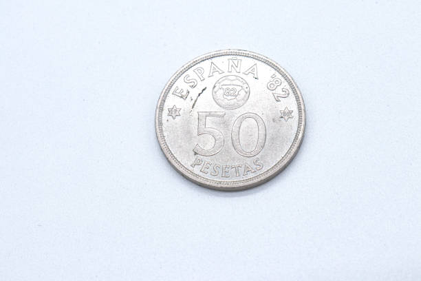 istock 50 pesetas old spanish coins on white background 1409473839