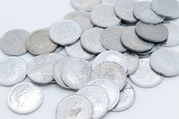 istock pesetas old spanish coins scattered on white background 1409473861