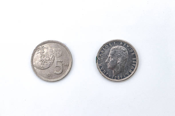 istock 5 pesetas old spanish coins on white background 1409473889