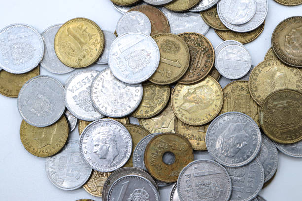 istock pesetas old spanish coins scattered on white background 1409473906