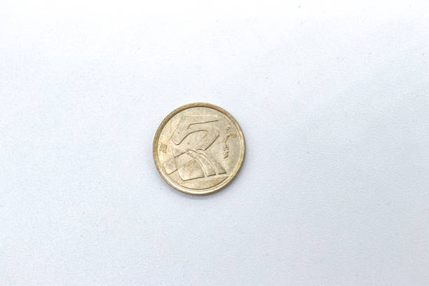 istock 5 pesetas old spanish coins on white background 1409473935
