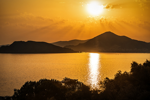 Beautiful sunset or sunrise over sea and mountains. Vacation theme. Adriatic sea