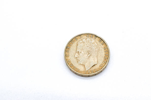 istock 100 pesetas old spanish coins on white background 1409474077