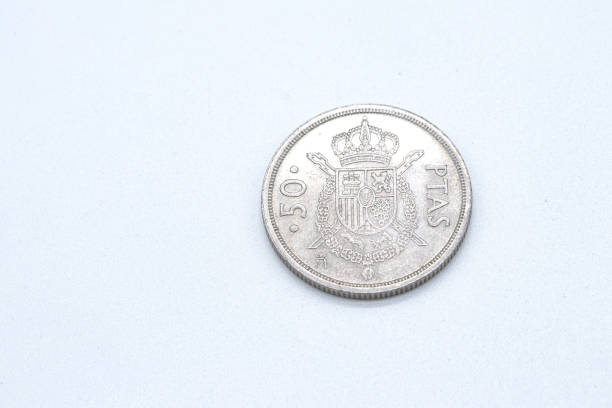 istock 50 pesetas old spanish coins on white background 1409474098