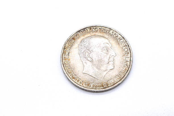 istock 100 pesetas 1966 old spanish coins on white background 1409474187