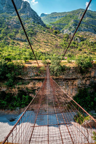 istock Extreme suspension iron rusty bridge across the river Moraca. Montenegro 1409475048