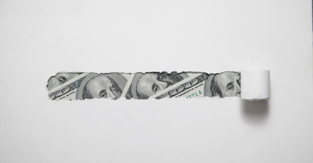 istock Hole ripped in paper with a dollar. 1409479133