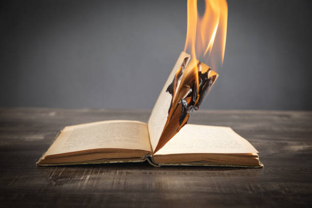 istock Burning book on the wooden table. 1409479165