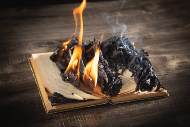 istock Burning book on the wooden table. 1409479193