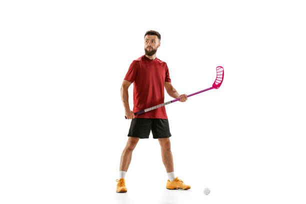portrait of young man, floorball player with floorball stick isolated on white background. sport, competition and motion, movement, active lifestyle - teamsport imagens e fotografias de stock