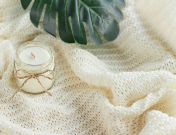 istock Handmade soy wax candle with green leaves 1409481519