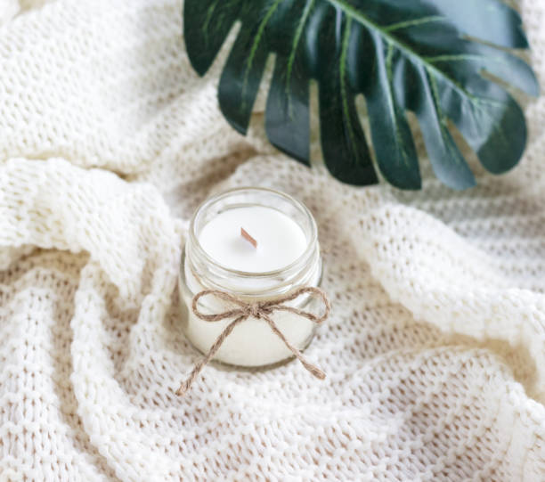 istock Handmade soy wax candle with green leaves 1409481521