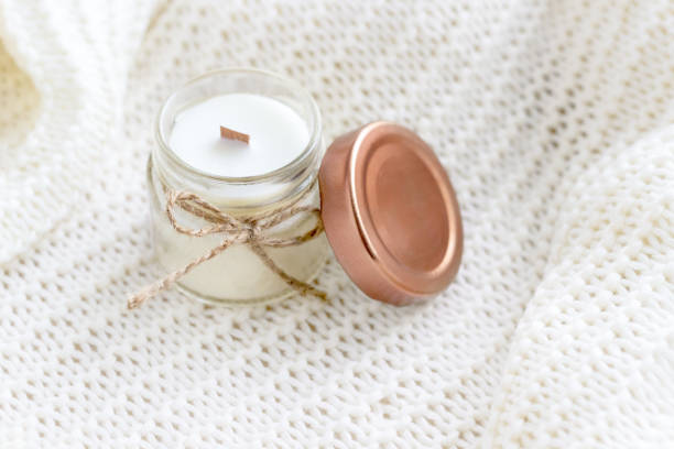 istock Soy wax candle on white cozy blanket 1409481536