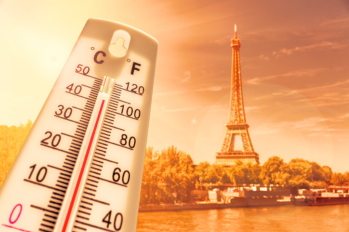 Thermometer in front of Paris skyline during heatwave in France