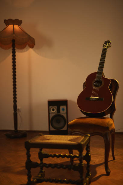 istock Acoustic guitar in a retro vintage room. 1409485716