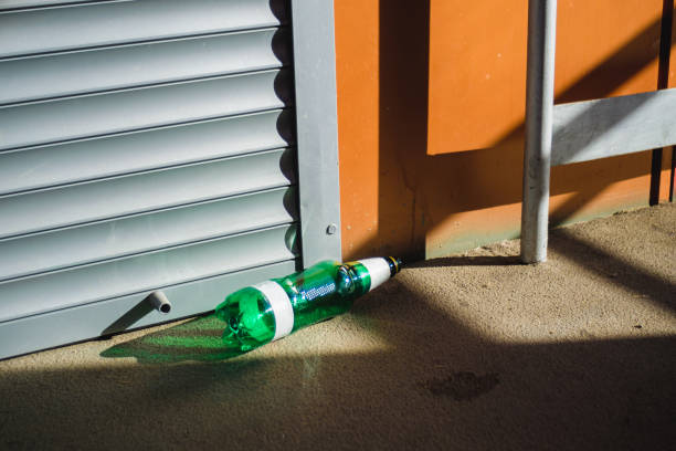 istock a plastic beer bottle is lying on the floor in a public place. Bright sunlight 1409485813