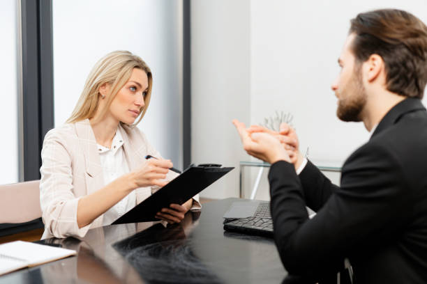 istock Bright idea. Joyful young qualified colleagues are sitting at table in office and discussing their project with smile. Woman is holding documents 1409486483