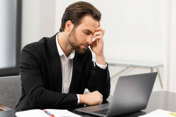 istock Tired male office employee suffering from strong headache 1409486511