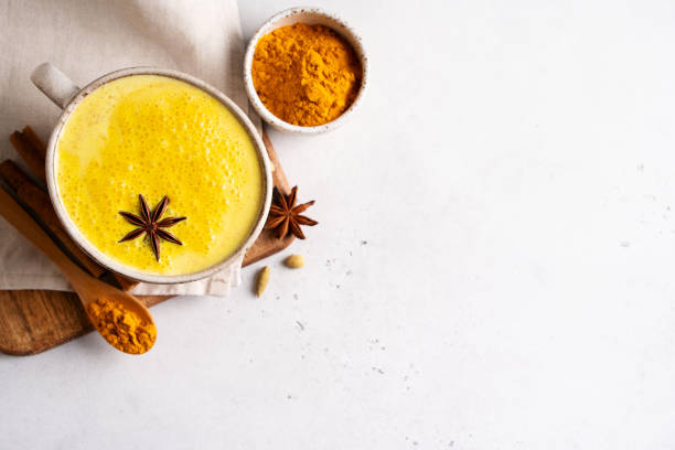 istock Turmeric health latte with spice and powder on white background, 1409486573