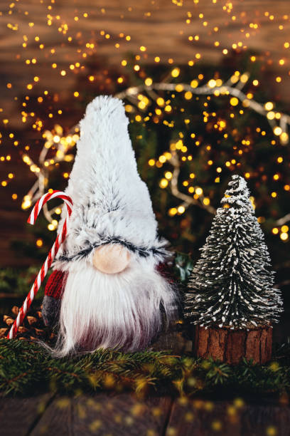istock Christmas composition with gnome and festive decorations on wooden background. 1409489001