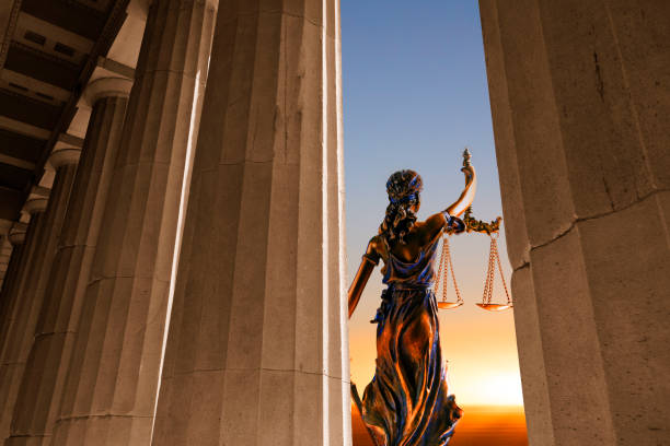 istock Lady Justice In Front Of Rows Of Columns At Sunset 1409490609