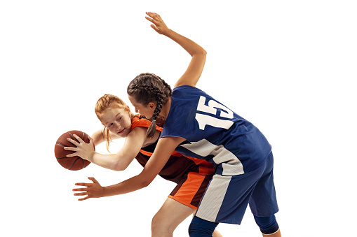 istock Two basketball players, young girls, teen playing basketball isolated on white background. Concept of sport, team, enegry, competition, skills 1409491021