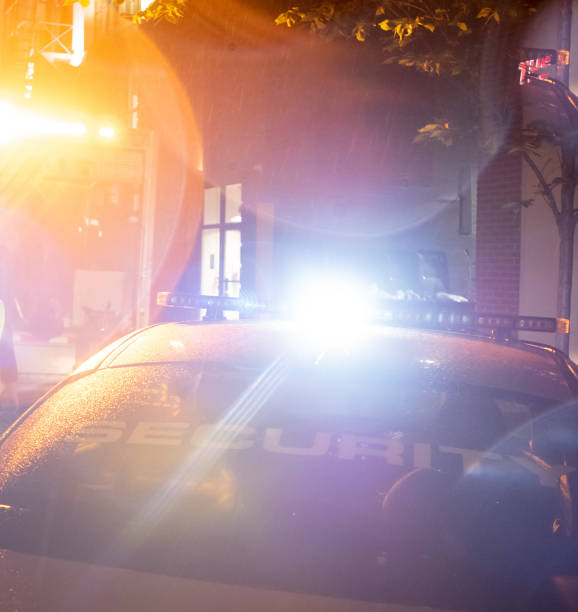 istock Security car patroling at construction site at night  city 1409491264