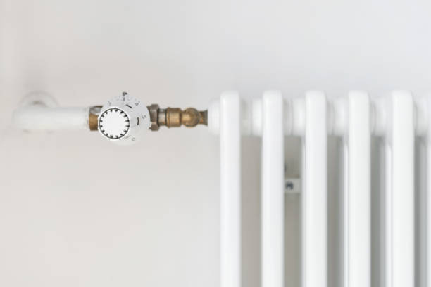 istock Close up view of adjusting knob on heating radiator 1409492912
