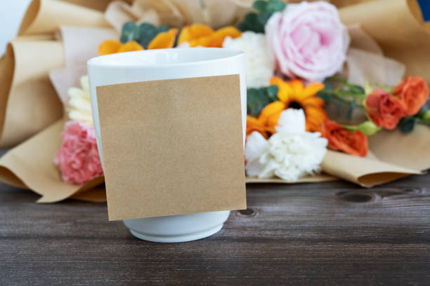 Adhesive note stick on cup of drink with flower bouquet